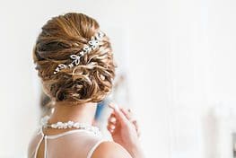 A woman with long hair and a tiara on her head.