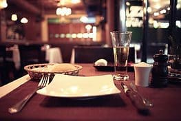 A table with plates, cups and silverware on it.