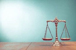 A gold scale sitting on top of a wooden table.