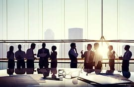 A group of people standing around a table.