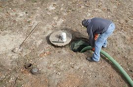 A man working on the ground near a fire hydrant.