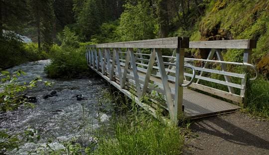 A wooden bridge crossing over a river.