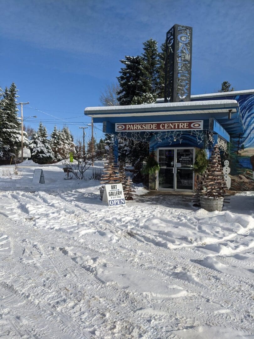 A blue building with snow on the ground